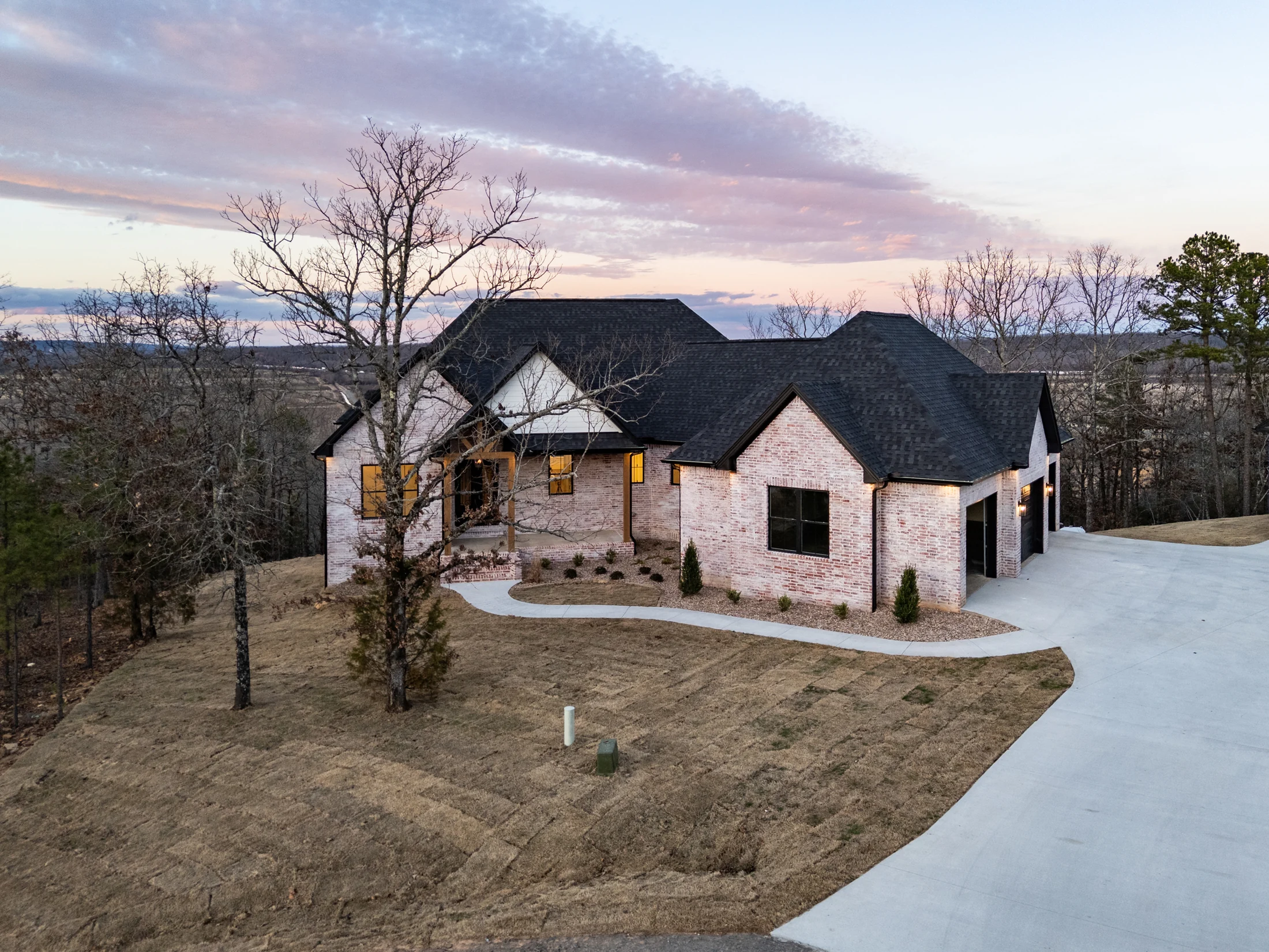 EM Builders custom home exterior at dusk